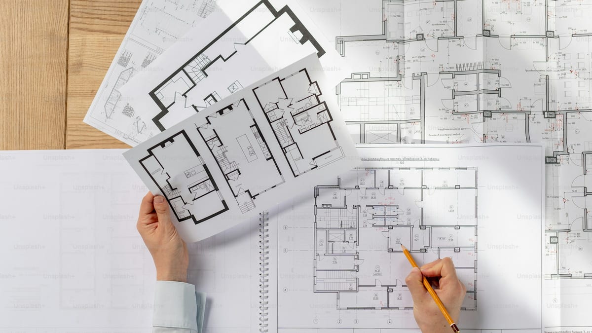 Overhead view of an architect working at a drafting desk