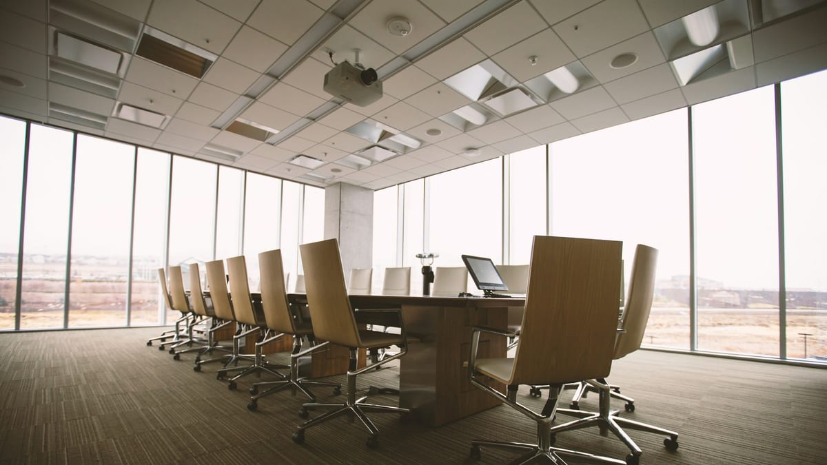 An oval boardroom table set for a meeting