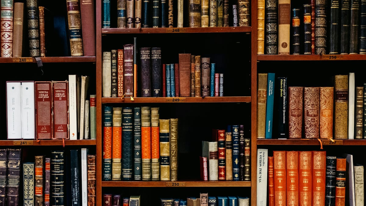 A wall of leather-bound legal reference books on wooden shelves